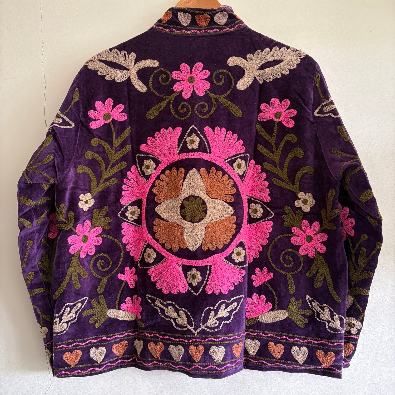 Embroidered purple Jacket with floral patterns on a white background