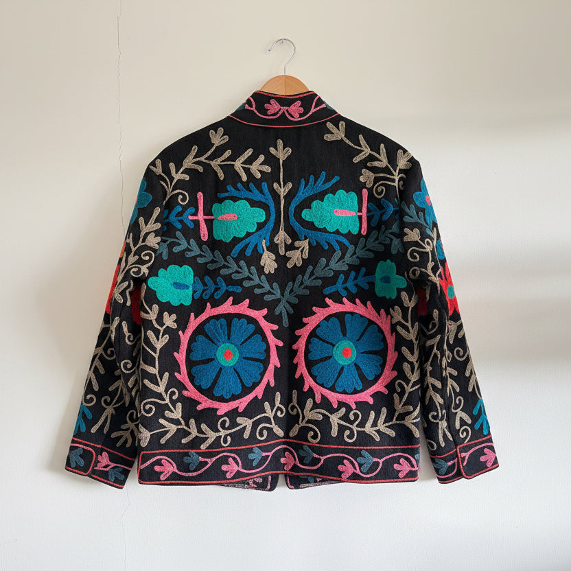 Embroidered fabric with colorful floral patterns on a plain background