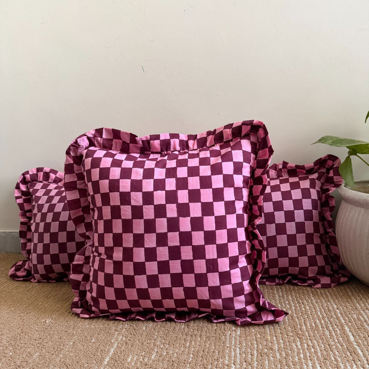 Pink and deep burgundy checkerboard design cushion covers