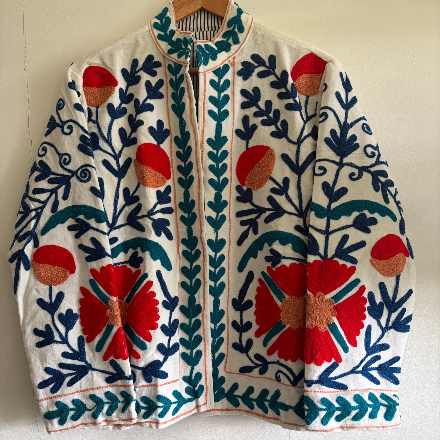 Embroidered fabric with floral patterns on a beige background