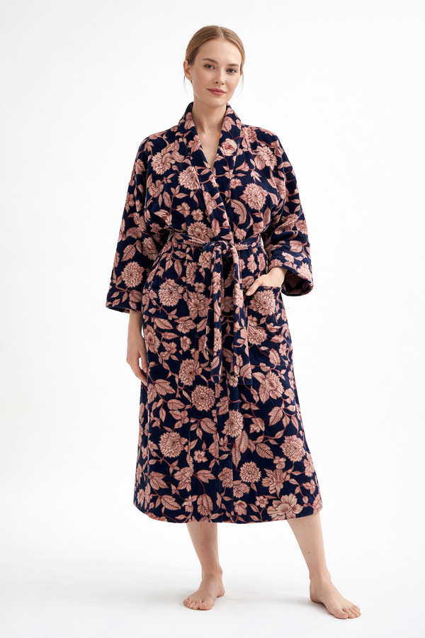 Woman wearing a floral patterned robe on a white background