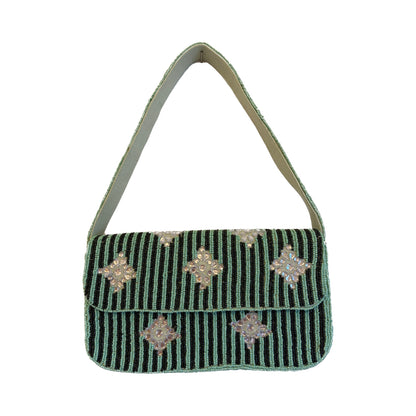 Green handbag with decorative elements on a white background
