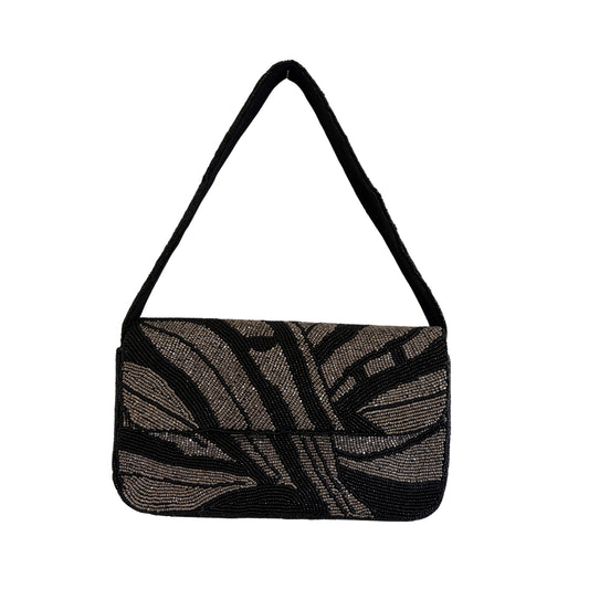 Black and gray patterned handbag with a strap on a white background
