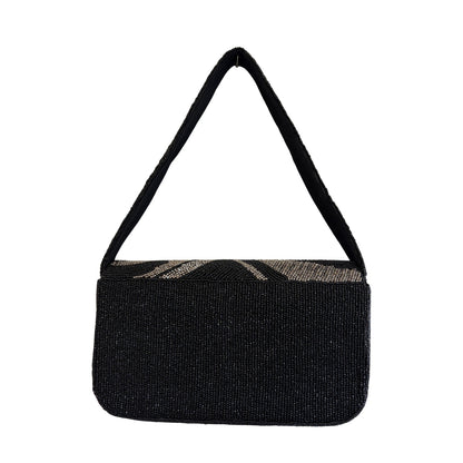 Black handbag with a strap on a white background