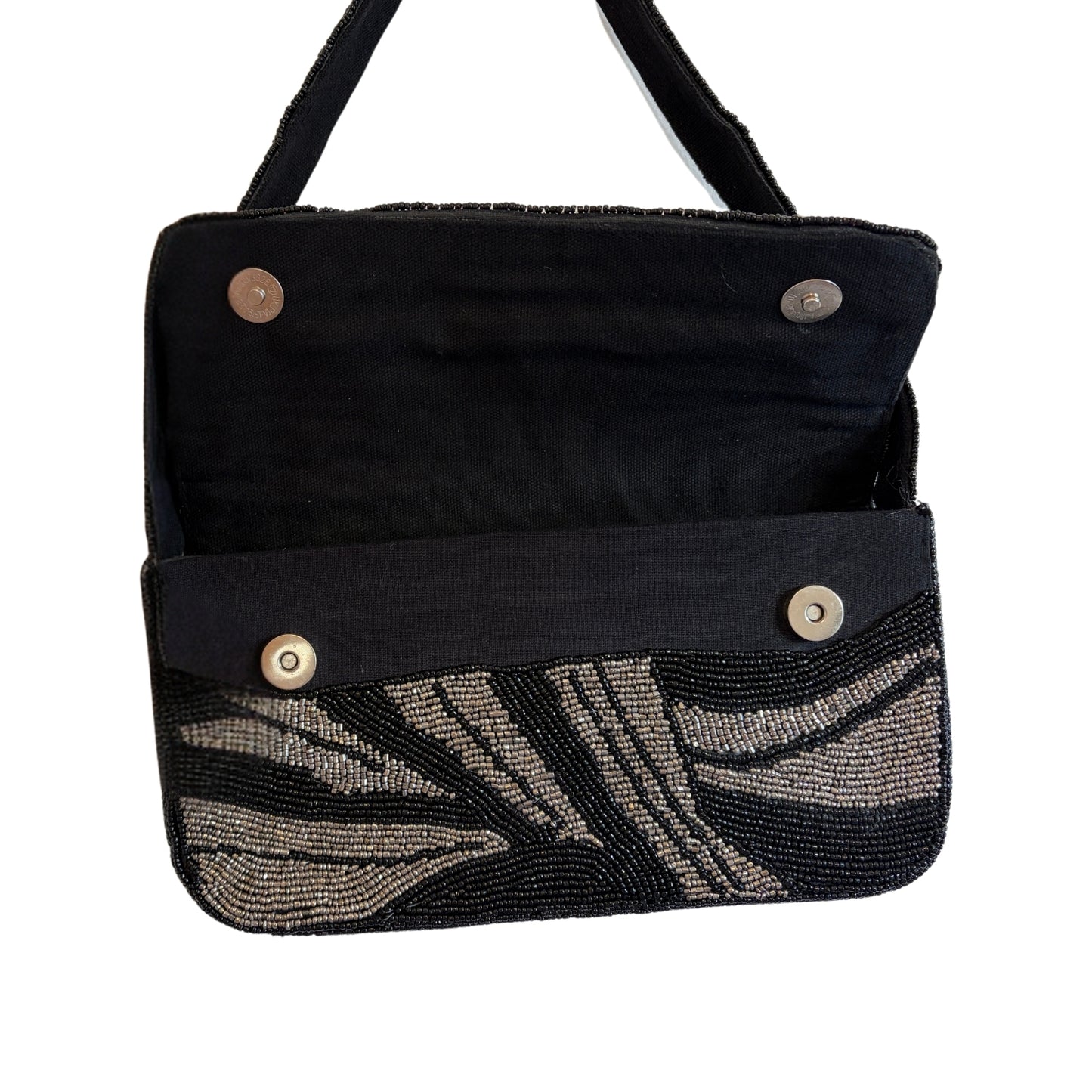 Black handbag with beaded leaf pattern on a white background