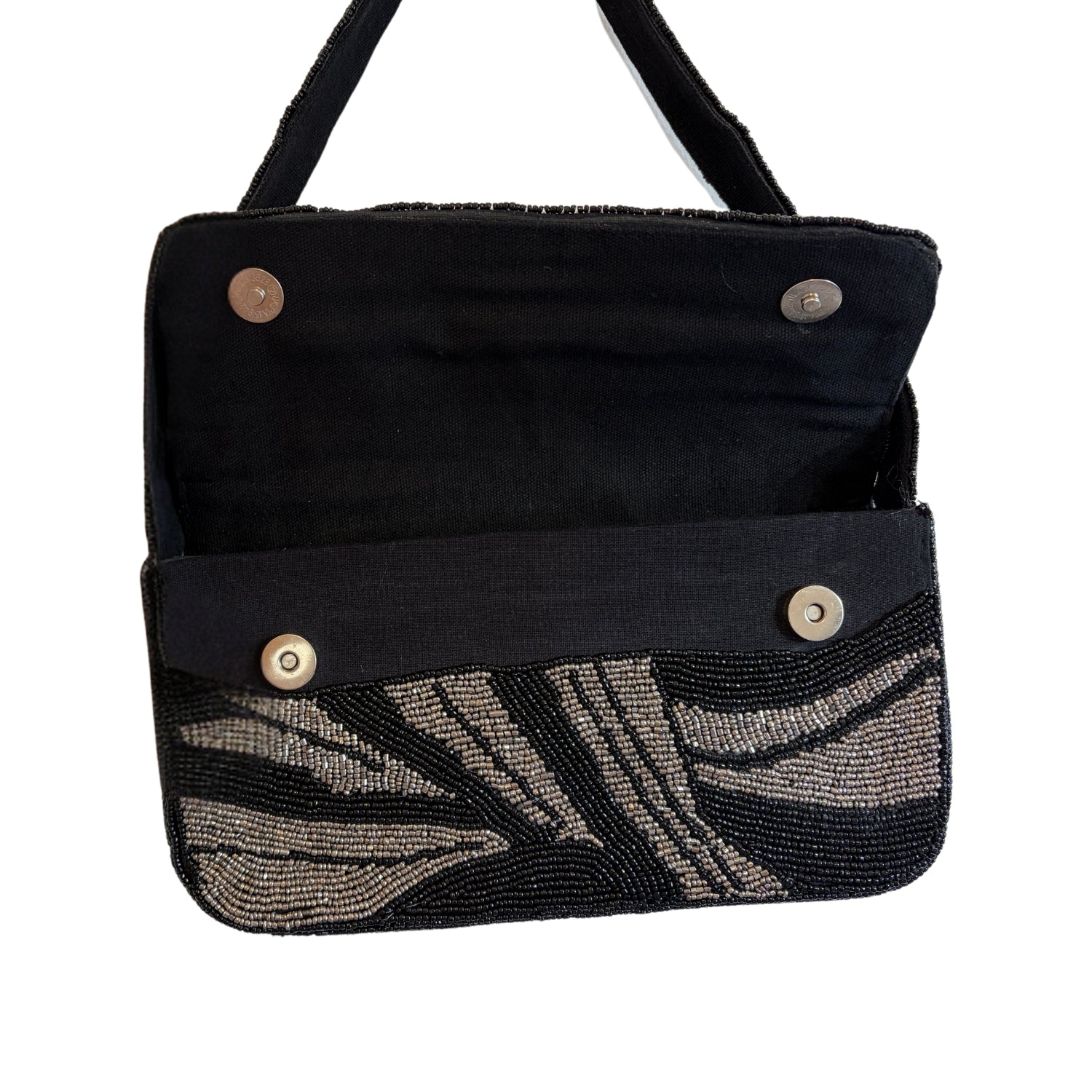 Black handbag with beaded leaf pattern on a white background