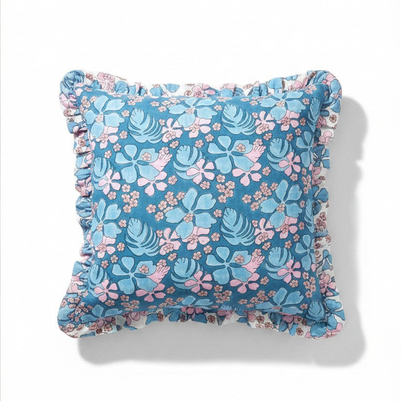 Blue floral pillowcase with pink and light blue tropical flowers and ruffled edges. 