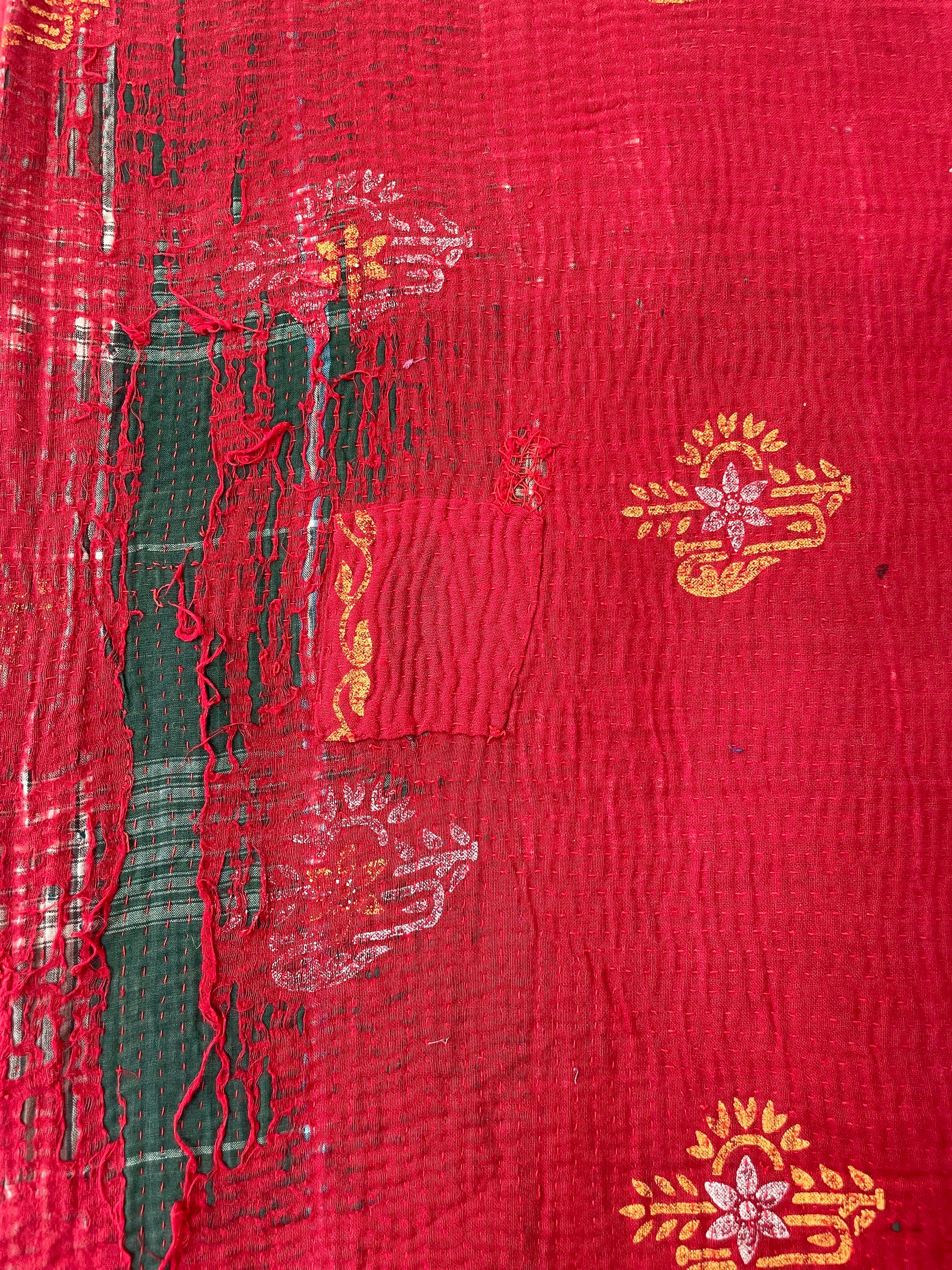 Red fabric with gold and white patterns