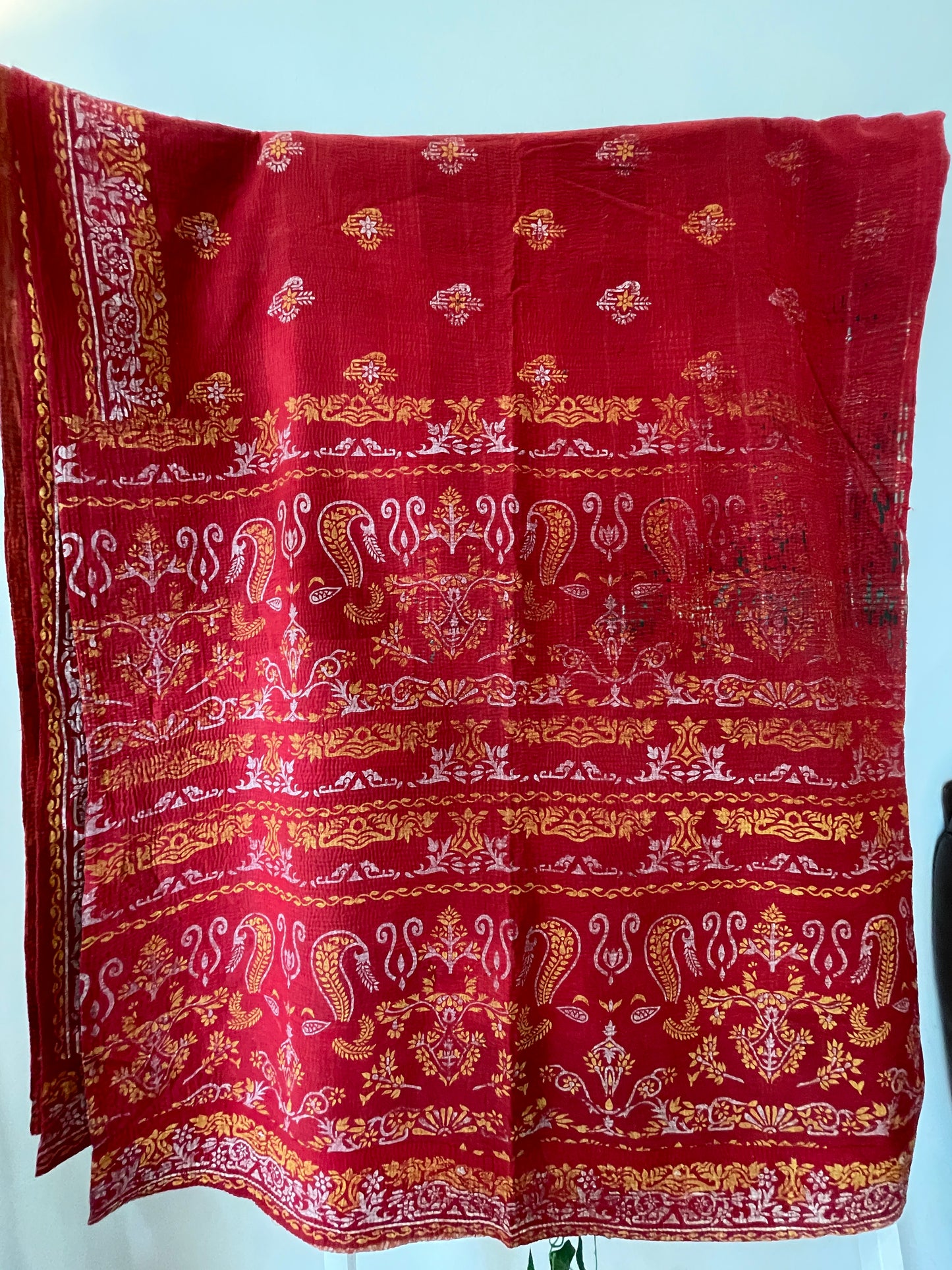 Red fabric with gold and white patterns vintage kantha bed throw